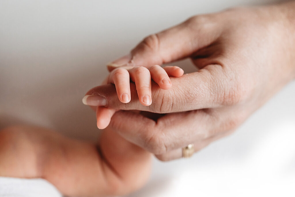 newborn hand with dad