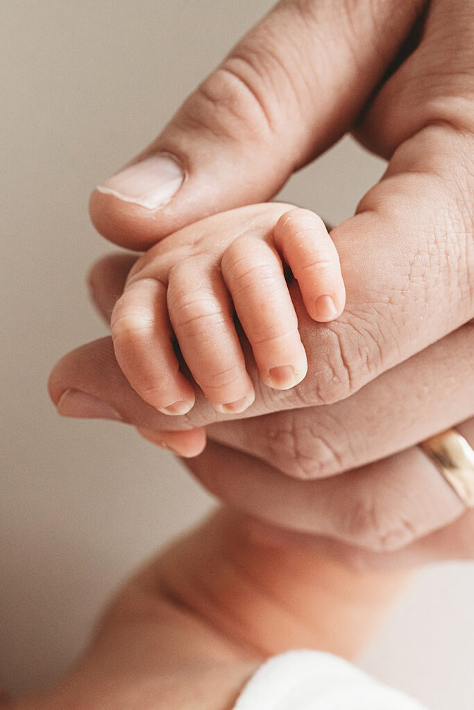 newborn baby hand with daddy