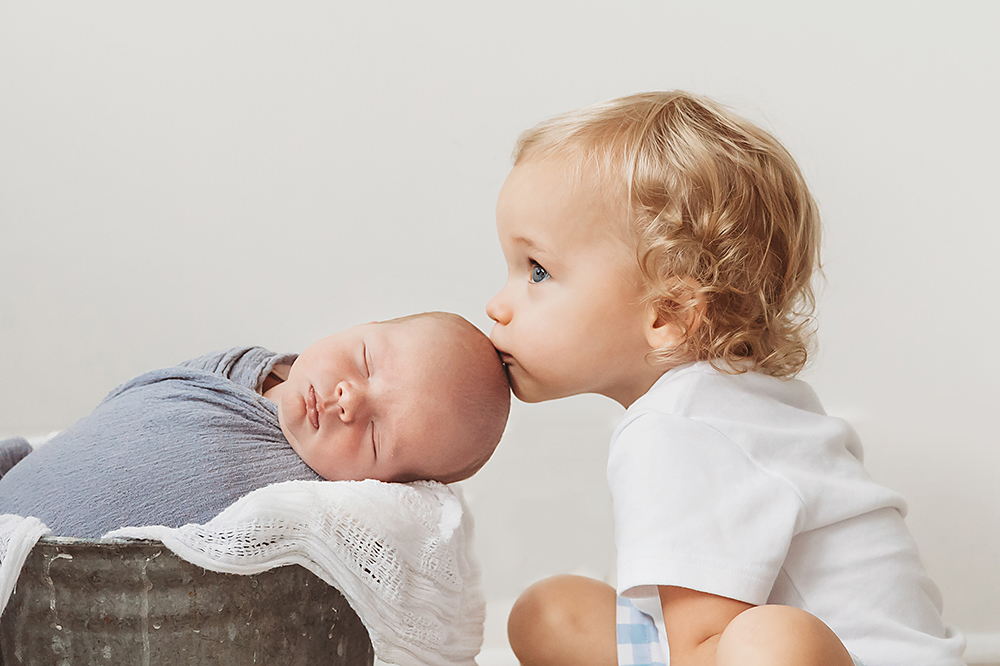 big brother kissing baby brother