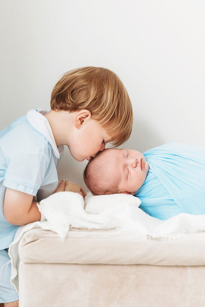 big brother kissing baby brother