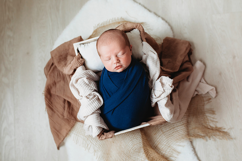 newborn baby in a bucket