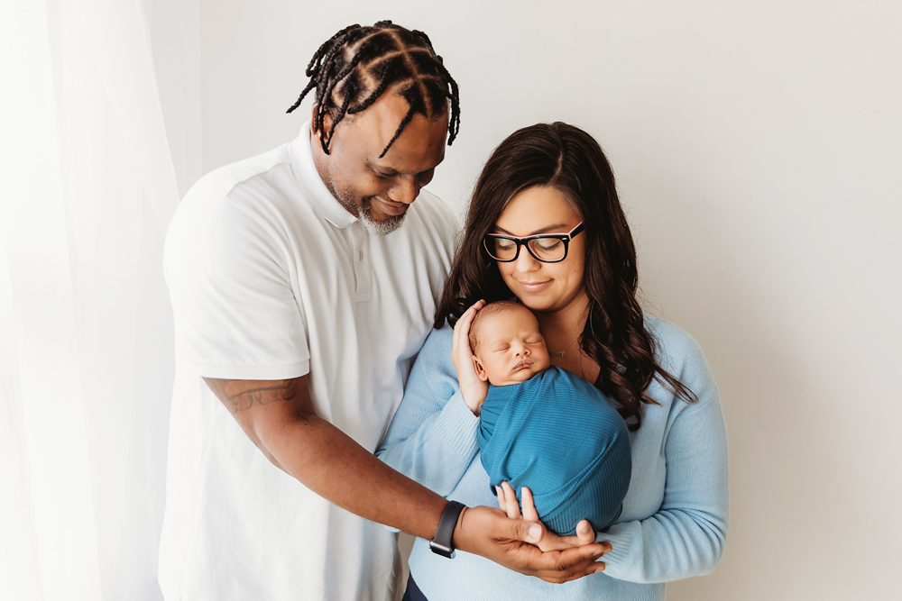 newborn baby pose with parents