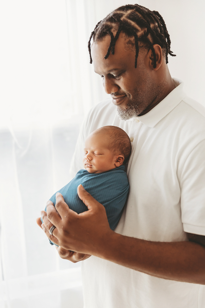 newborn baby pose with dad