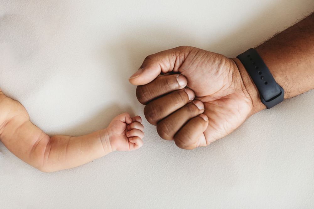 newborn baby hand with dad