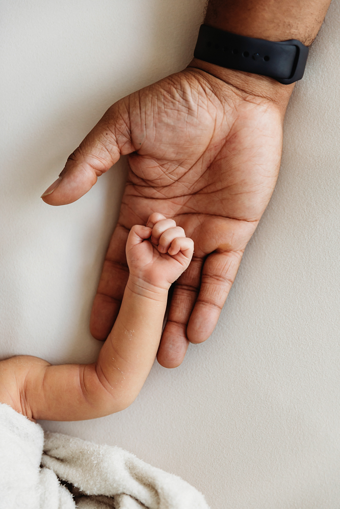 newborn baby boy hand in dads