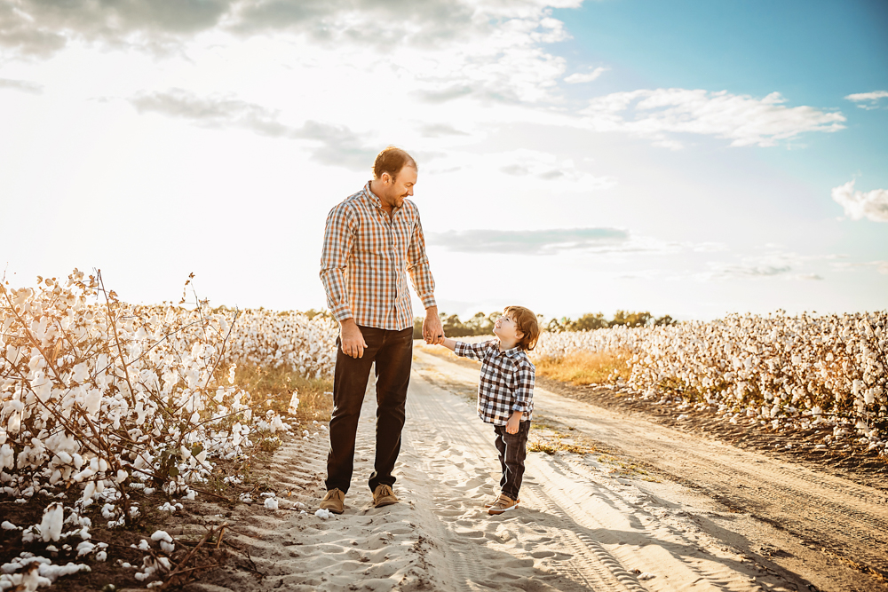 father son walking on a dirt road