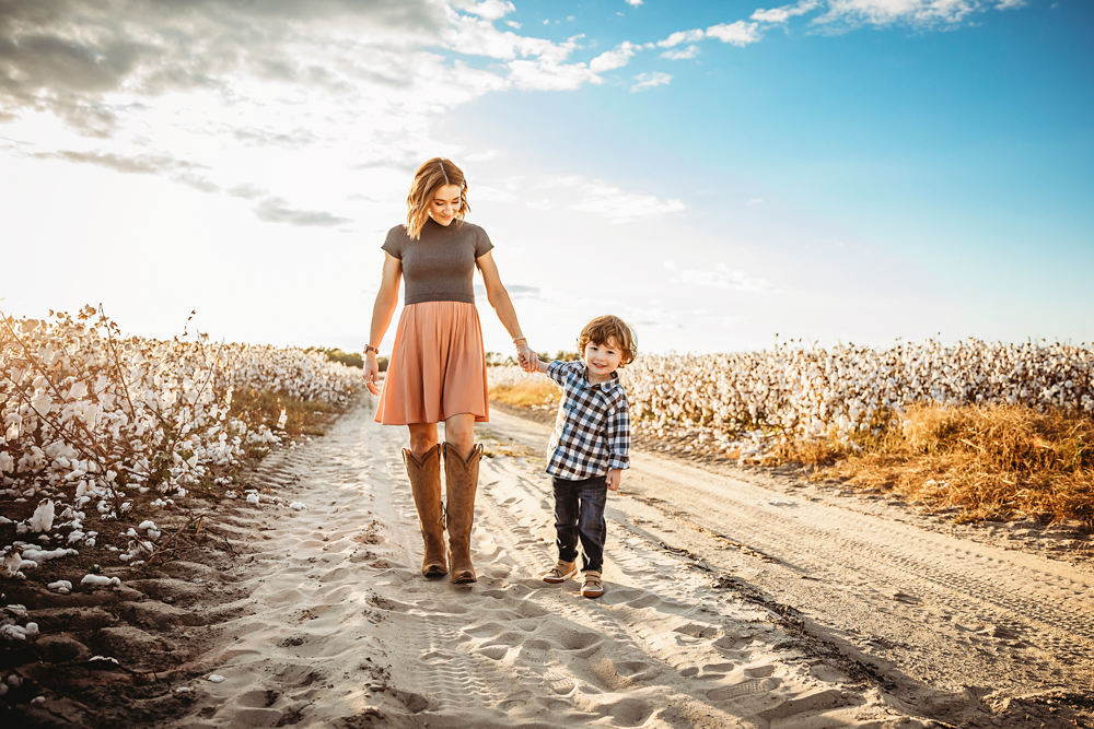 mom and son walking on a dirt road