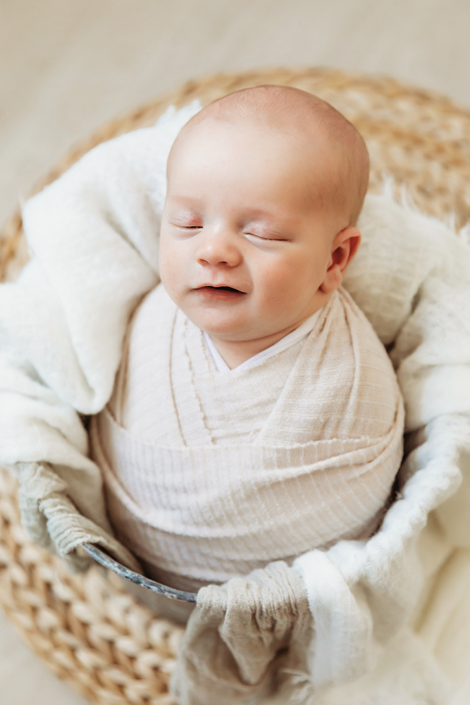 newborn baby boy smiling