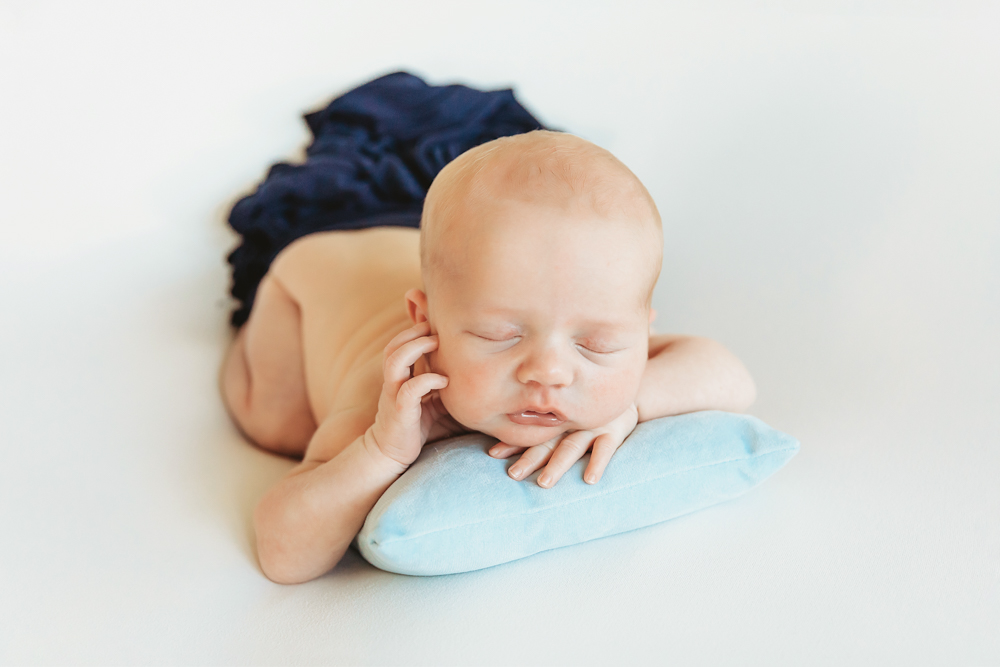 newborn baby pose on pillow