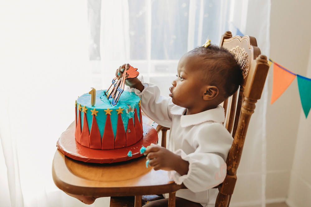 1st birthday baby eating cake