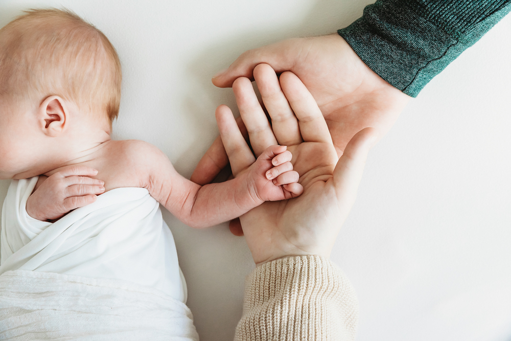 newborn hand with mom and dad