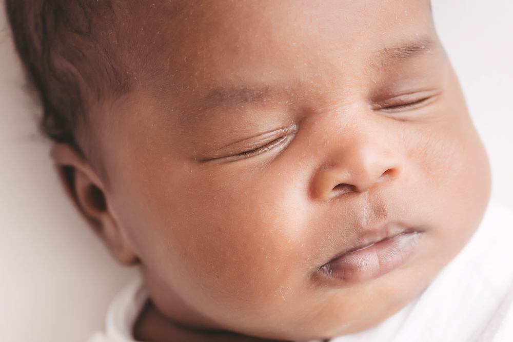 Newborn Lily extreme close up of eyelids, cheek, and soft baby fuzz at Reflection Images by Tracy Rowell in Florence SC
