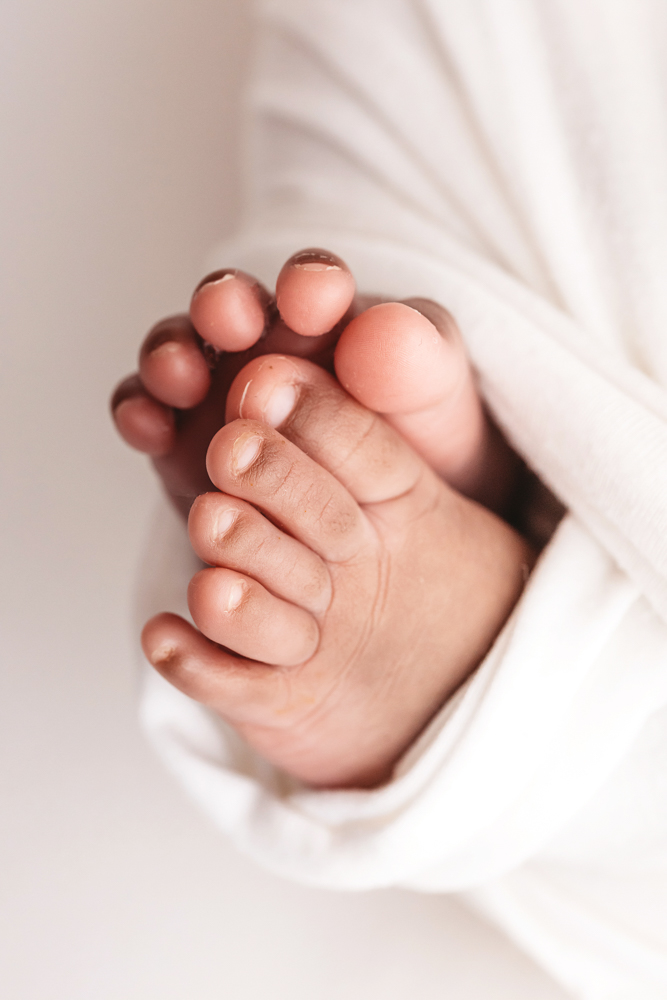 African American newborn Lily vertical macro of a single foot with curled newborn toes at Reflection Images by Tracy Rowell in Florence SC