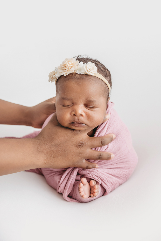 Newborn Lily supported pose with hands on chin and toes peeking out at Reflection Images by Tracy Rowell in Florence SC