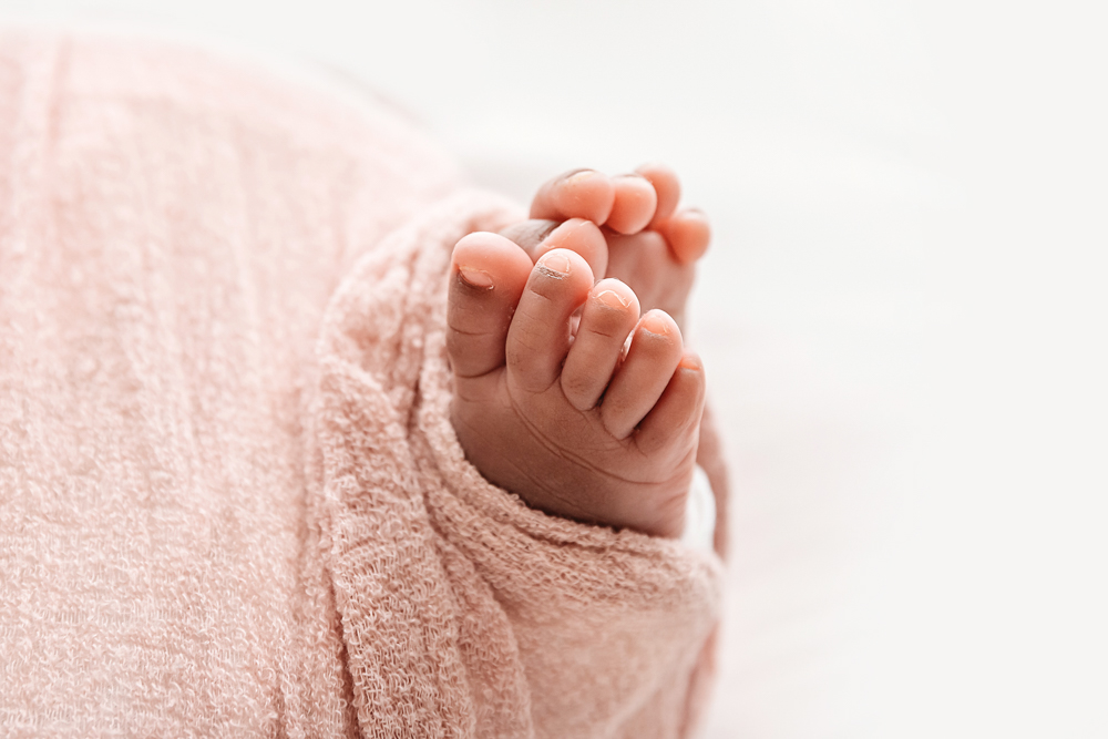 Newborn Lily detail of tiny toes wrapped in blush textured fabric at Reflection Images by Tracy Rowell in Florence SC