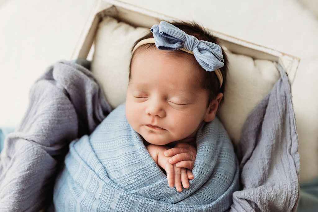 newborn baby girl in light blue