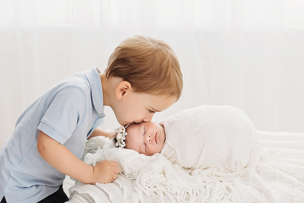 big brother kissing baby sister
