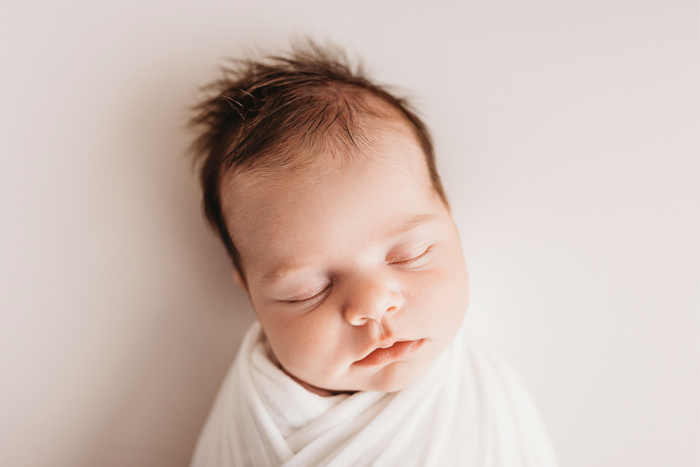 simple white natural newborn pose