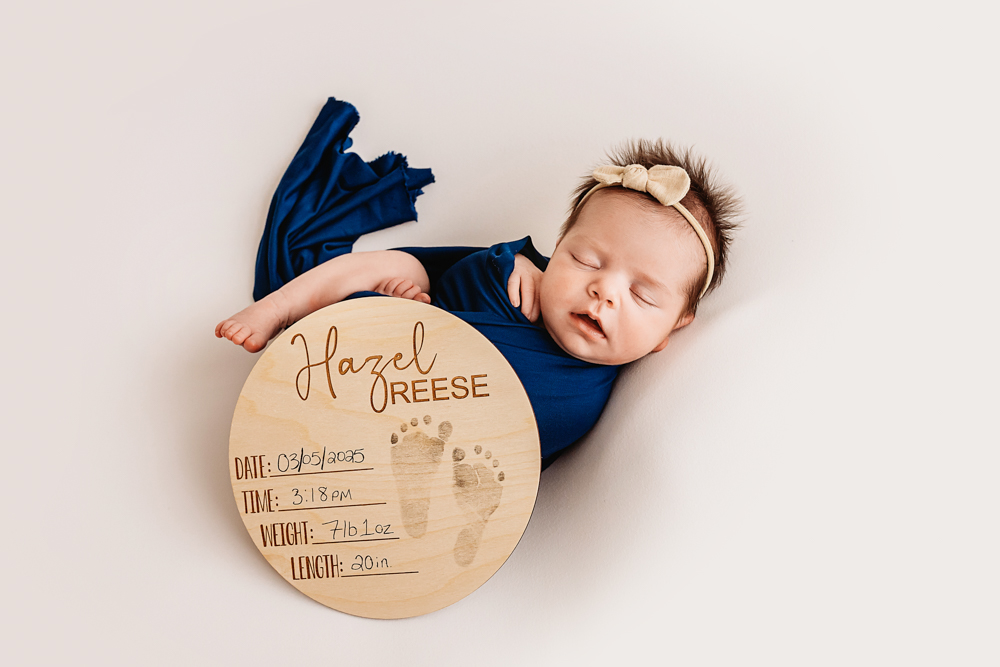 newborn with name plate