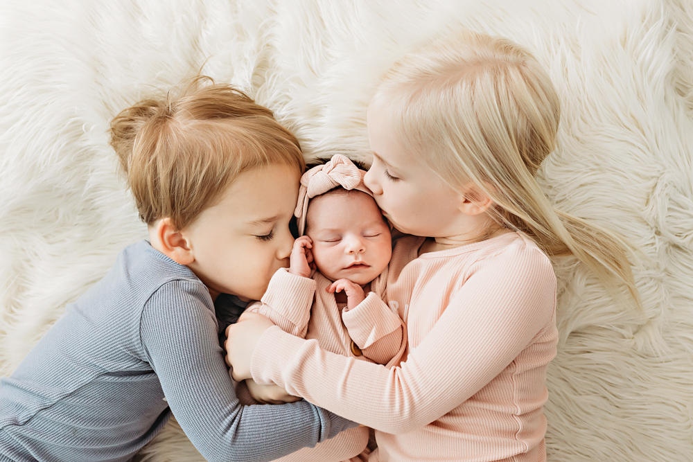newborn baby with brother and sister