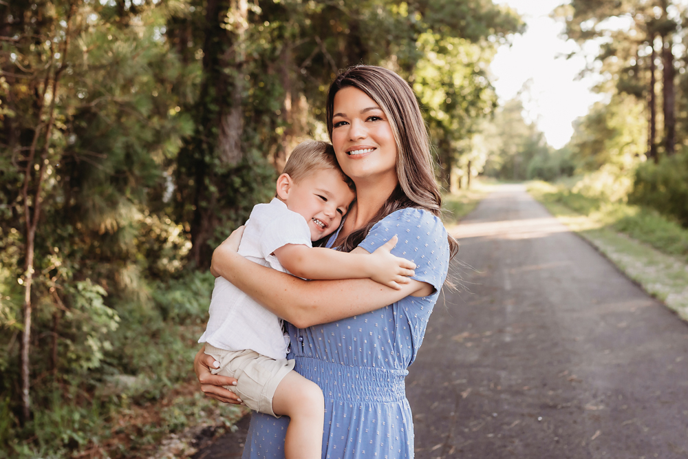 mom squeeze son with natural light, smiles, and love at Reflection Images by Tracy Rowell in Florence SC
