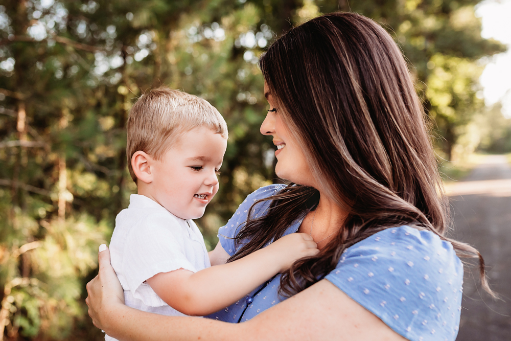 toddler hug tight with natural light, smiles, and love at Reflection Images by Tracy Rowell in Florence SC