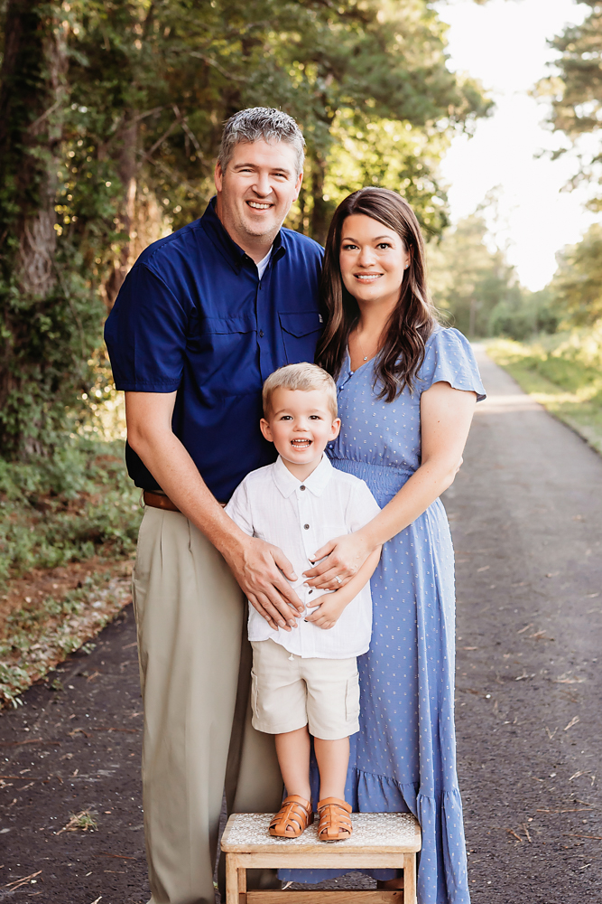 family hugging woods with natural light, smiles, and love at Reflection Images by Tracy Rowell in Florence SC