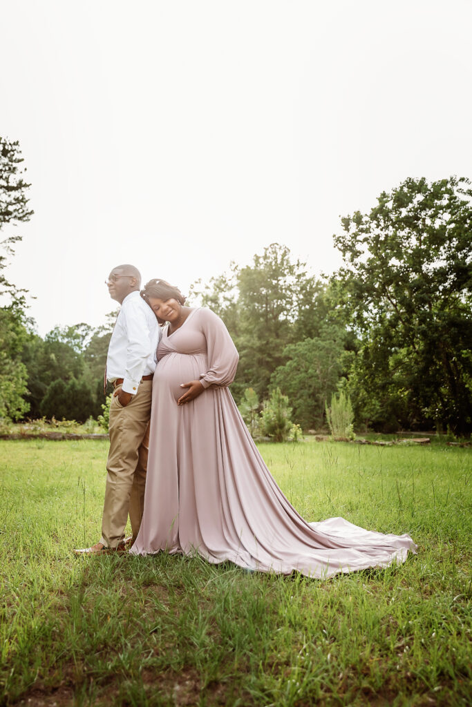 Back to back pose with Chelsea leaning on his shoulder, sunlit field and trees in Florence SC.
