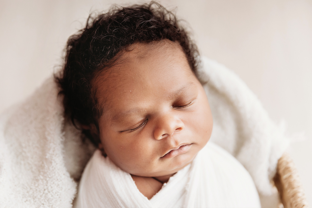 Close-up of Braylens peaceful face wrapped in white with soft texture detail at Reflection Images by Tracy Rowell in Florence SC