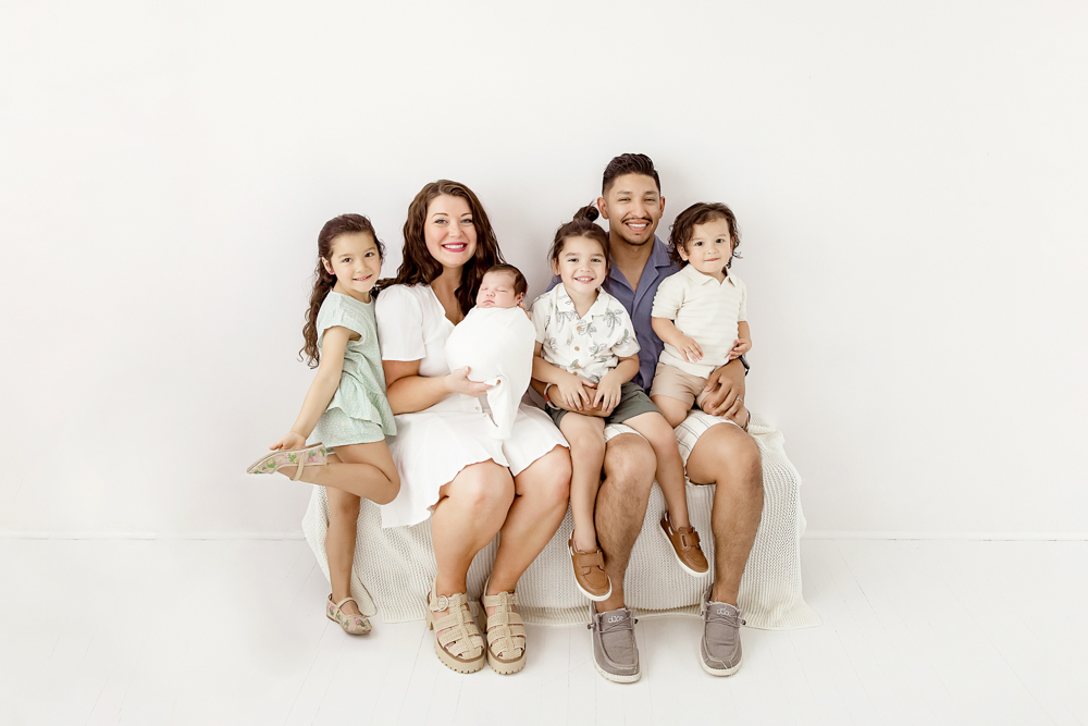 Smiling family portrait of the Buenrostros with newborn Finn in center at Reflection Images by Tracy Rowell in Florence SC