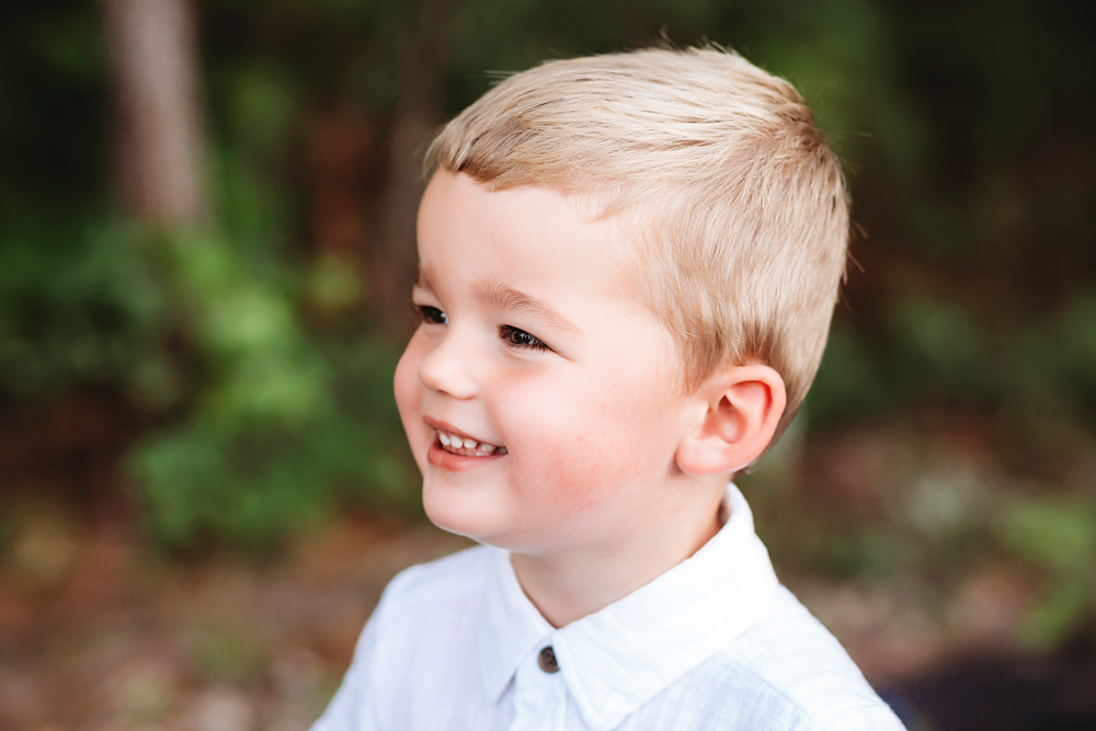 bright young boy profile expression woods with natural light, smiles, and love at Reflection Images by Tracy Rowell in Florence SC