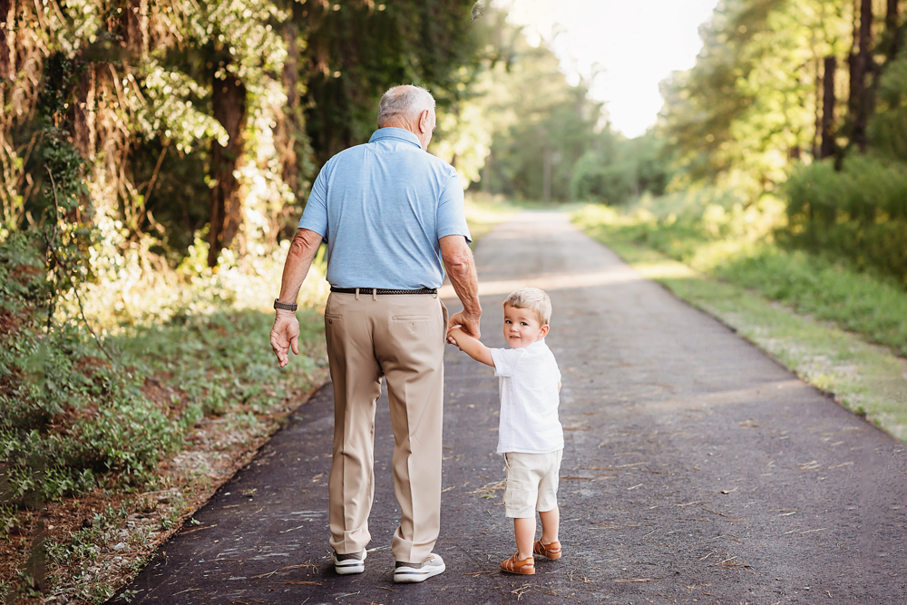 casual walk grandson and grandfather with natural light, smiles, and love at Reflection Images by Tracy Rowell in Florence SC