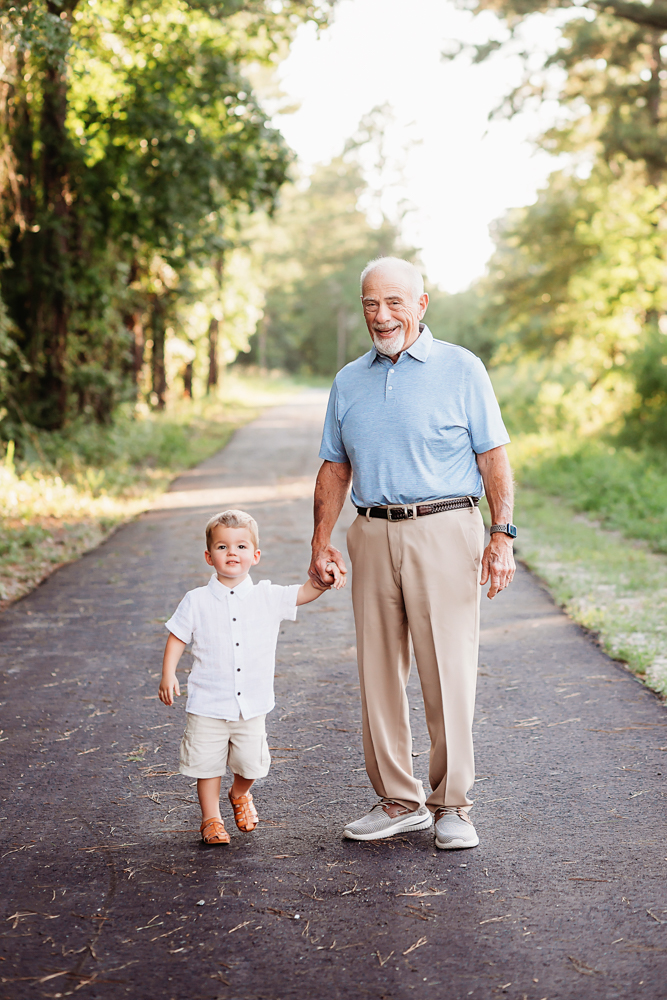 forest walk holdhands with natural light, smiles, and love at Reflection Images by Tracy Rowell in Florence SC