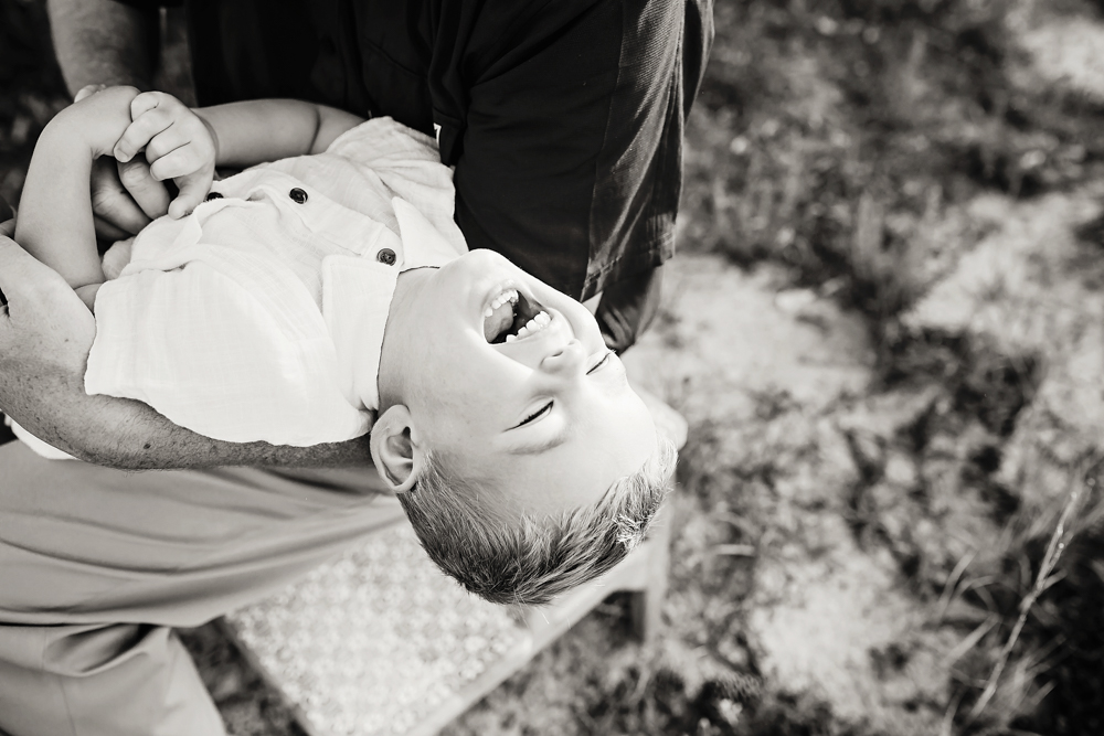 child twirl joy with natural light, smiles, and love at Reflection Images by Tracy Rowell in Florence SC