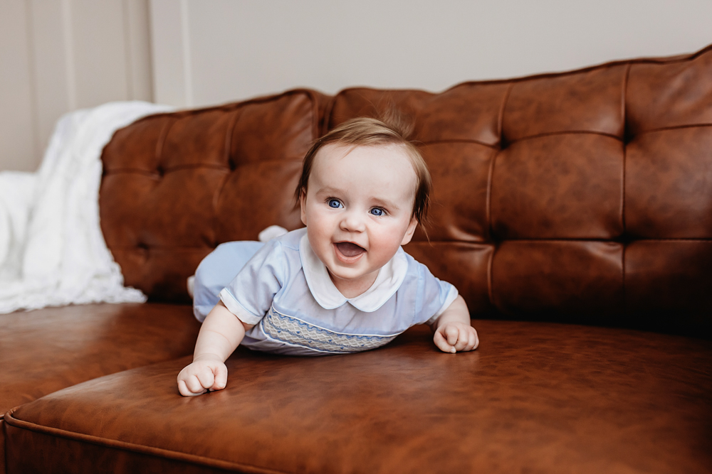 Baby boy tummy time on leather couch, professional baby milestone photography Florence SC