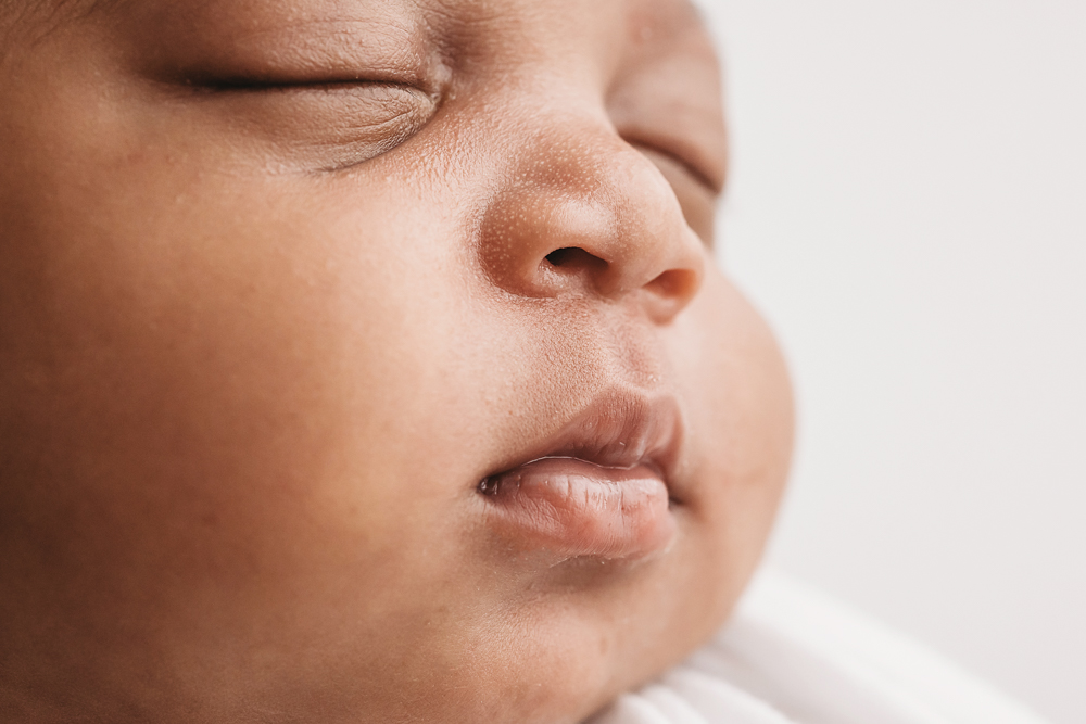Macro close-up of Harlems tiny nose and lips with soft newborn texture and gentle lighting at Reflection Images by Tracy Rowell in Florence SC