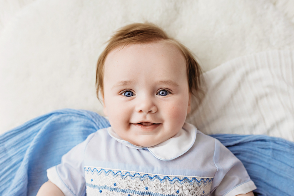 Baby boy looking up in natural light, Reflection Images by Tracy Rowell professional studio