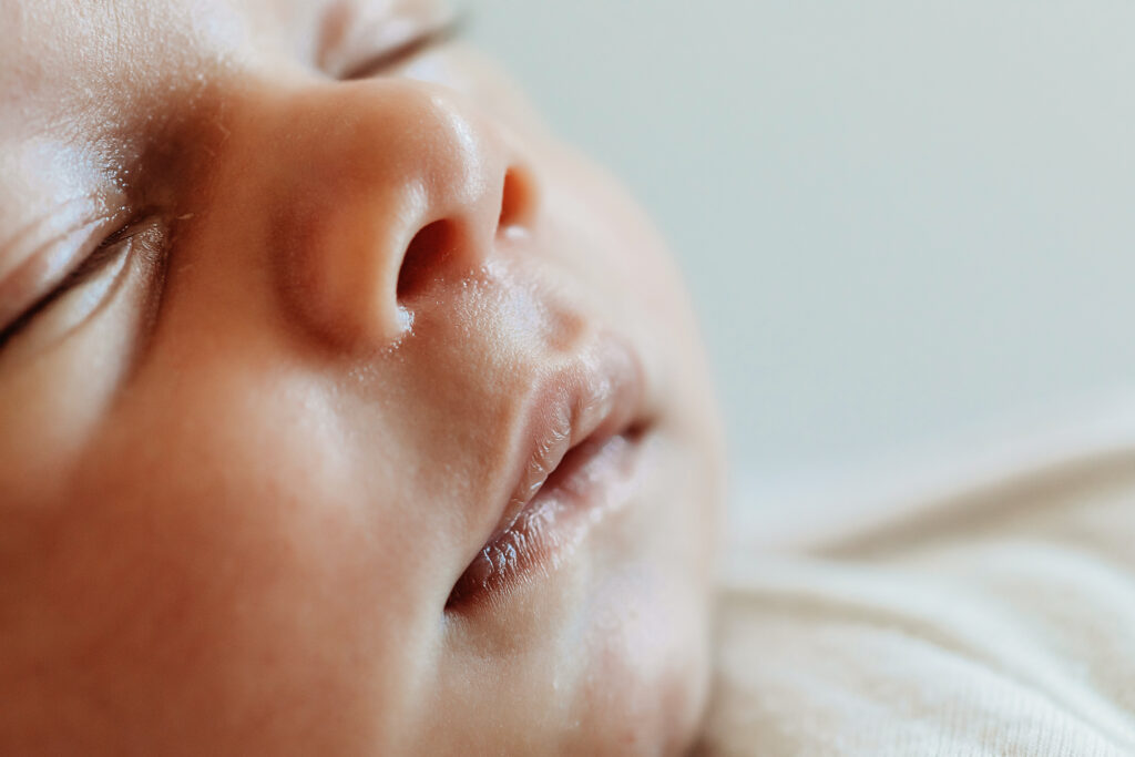 Profile macro showing newborns delicate nose and lips in soft light at Reflection Images by Tracy Rowell in Florence SC
