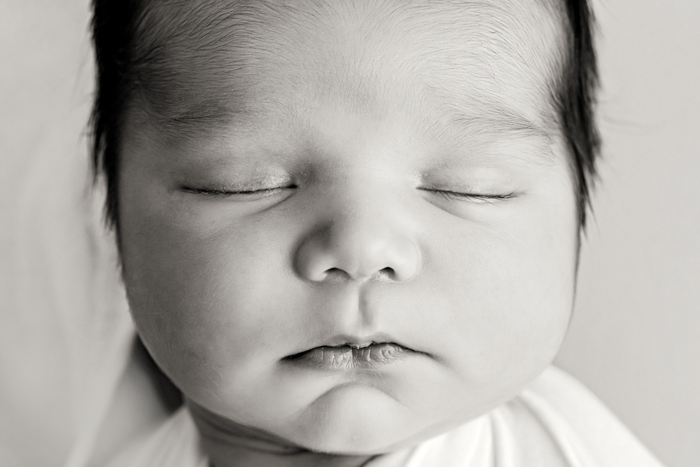 Macro black-and-white closeup of baby Finnâ€™s peaceful face at Reflection Images by Tracy Rowell in Florence SC