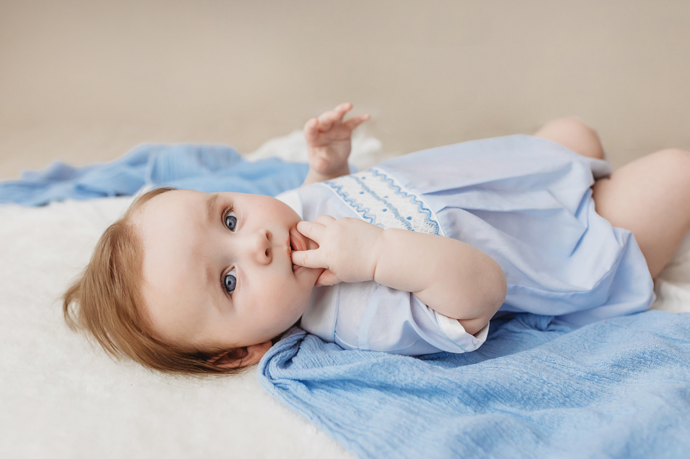 Baby boy in smocked romper sucking fingers, professional studio photography Florence SC