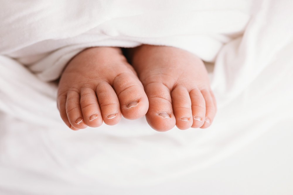 Macro close-up of Harrys tiny toes peeking through white swaddle at Reflection Images by Tracy Rowell in Florence SC