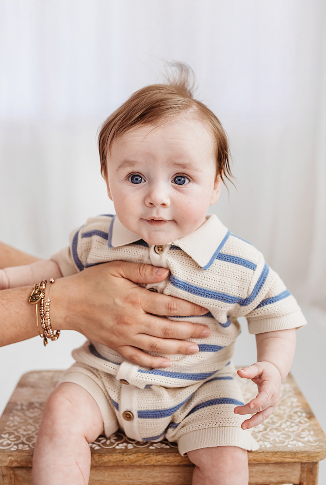 Baby sitting on patterned wooden stool, Reflection Images by Tracy Rowell studio portraits