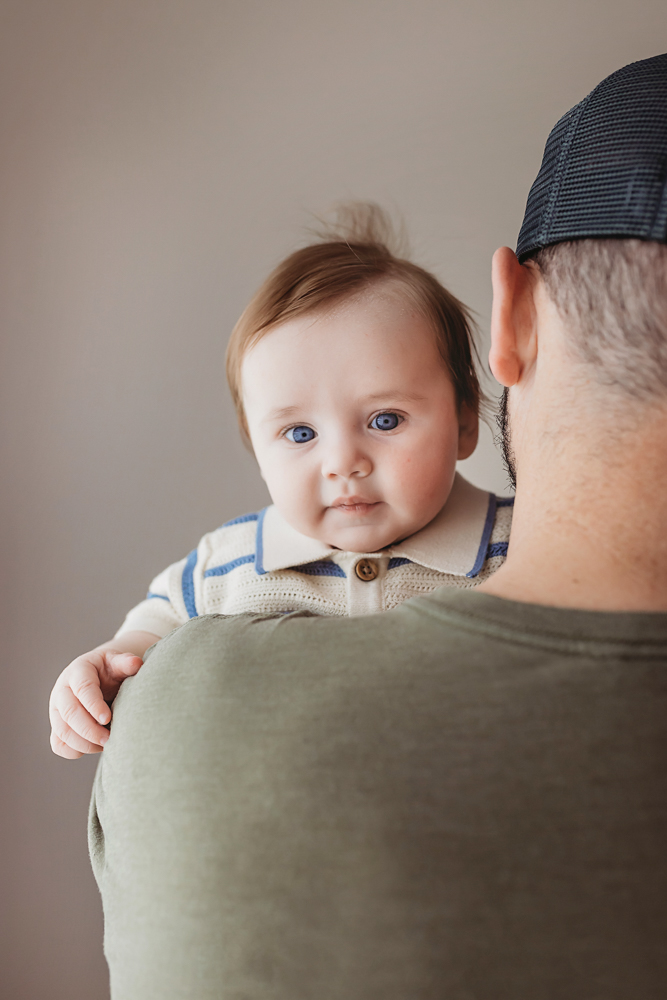 Baby looking over dads shoulder, Reflection Images by Tracy Rowell professional portraits
