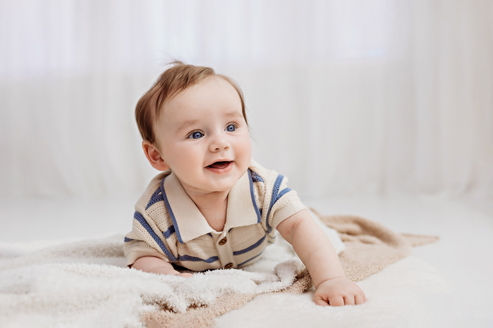 Baby boy on tummy smiling in natural light studio, newborn photographer Florence SC