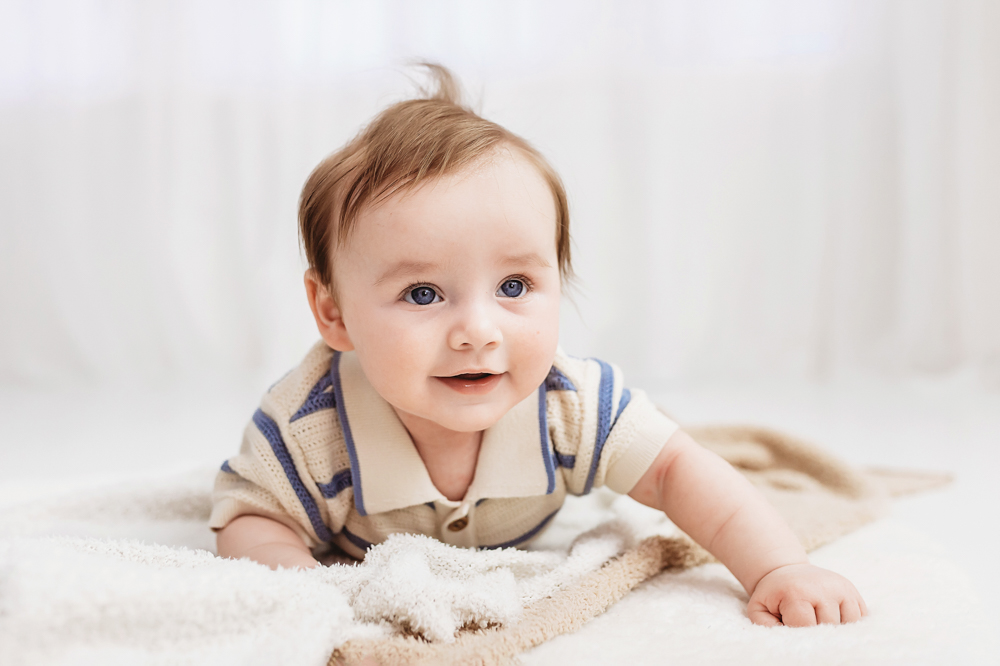 Baby crawling pose on white blanket, milestone photography near Florence SC