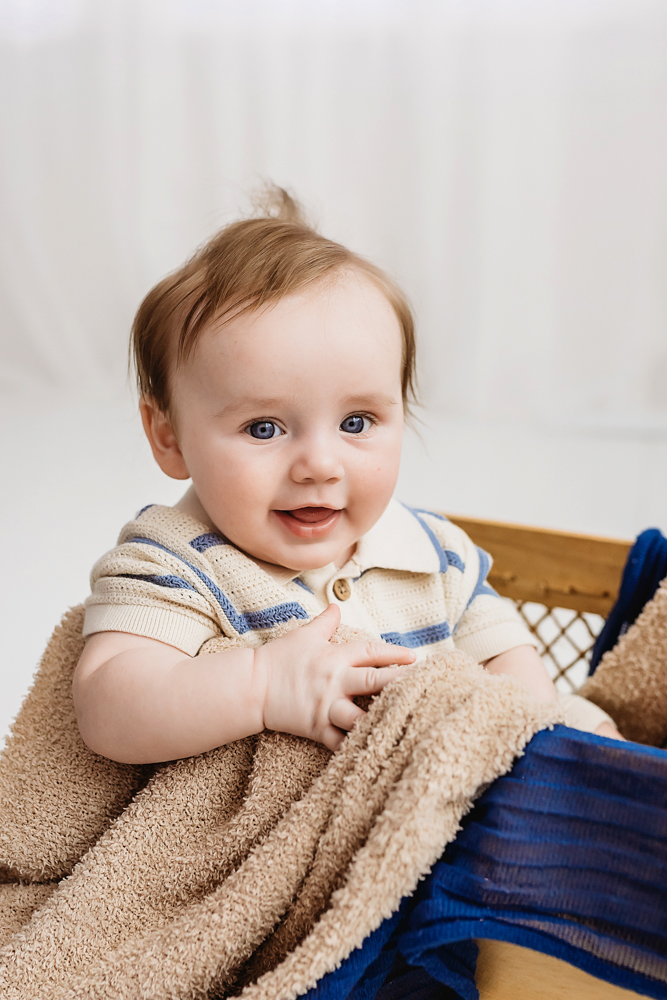 Baby boy in basket with brown and navy blankets, Reflection Images by Tracy Rowell studio photography