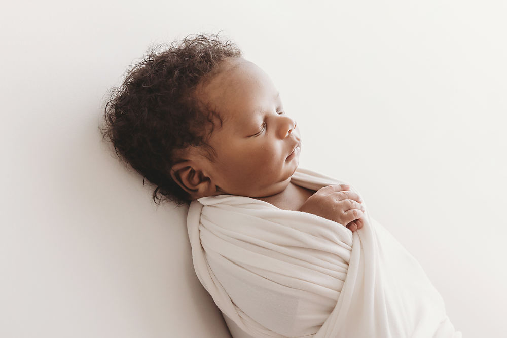 Side profile of Braylen in a soft white wrap with full cheeks and serene expression at Reflection Images by Tracy Rowell in Florence SC