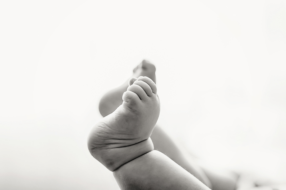Black and white artistic close-up of baby feet, Reflection Images by Tracy Rowell newborn photography