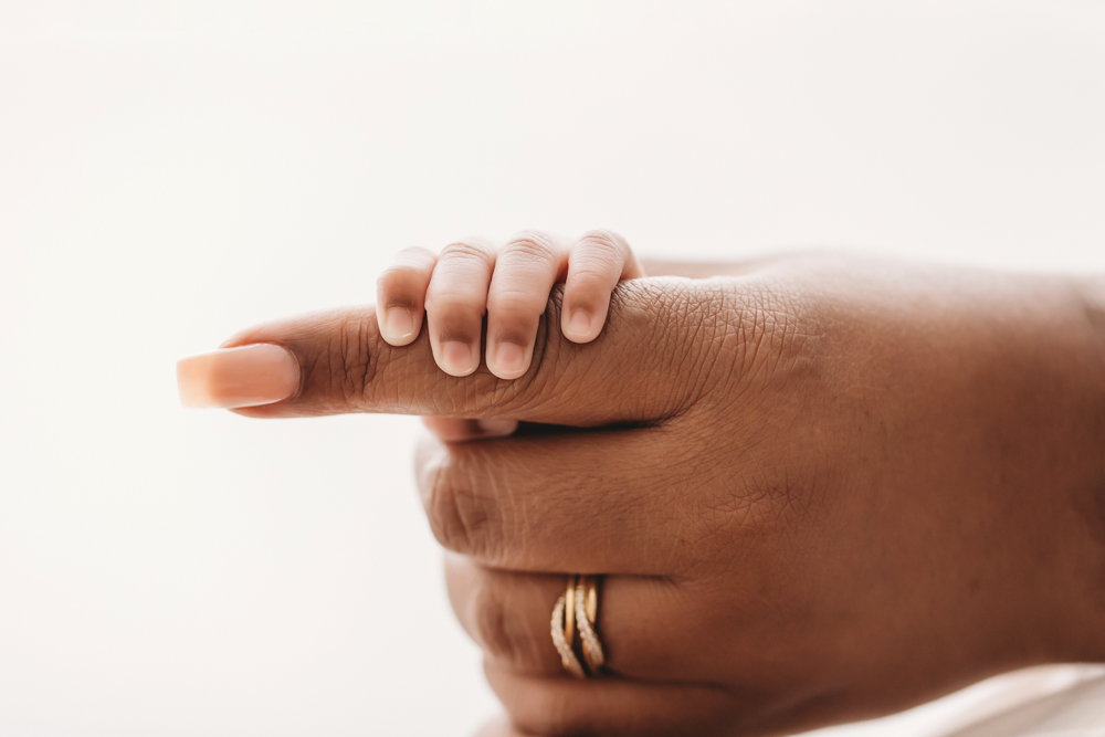 Braylens tiny fingers wrapped around his mothers finger, captured in a close, emotional moment at Reflection Images by Tracy Rowell in Florence SC