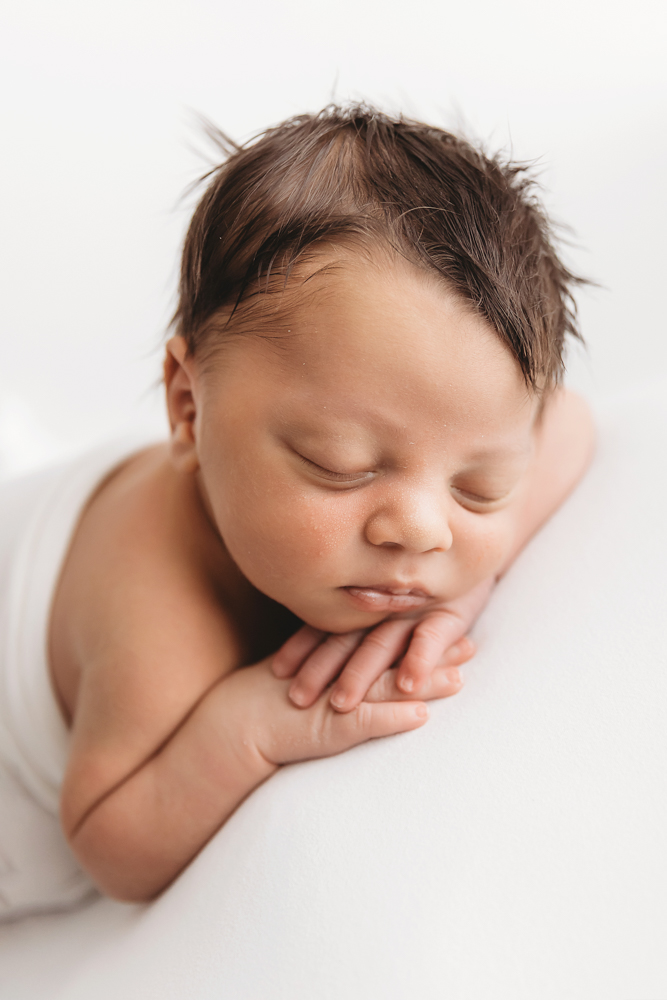 baby resting chin on hands front view lots of hair florence sc